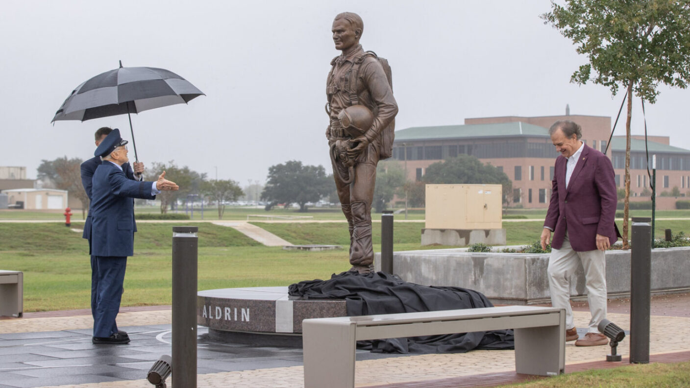 The Texas A&M University System circle logo; Statue of Buzz Aldrin at the former Bryan Air Force Base