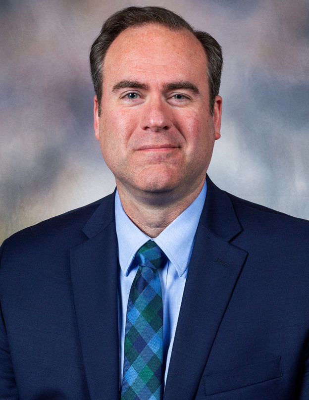 A headshot of Dr. Christopher Maynard.