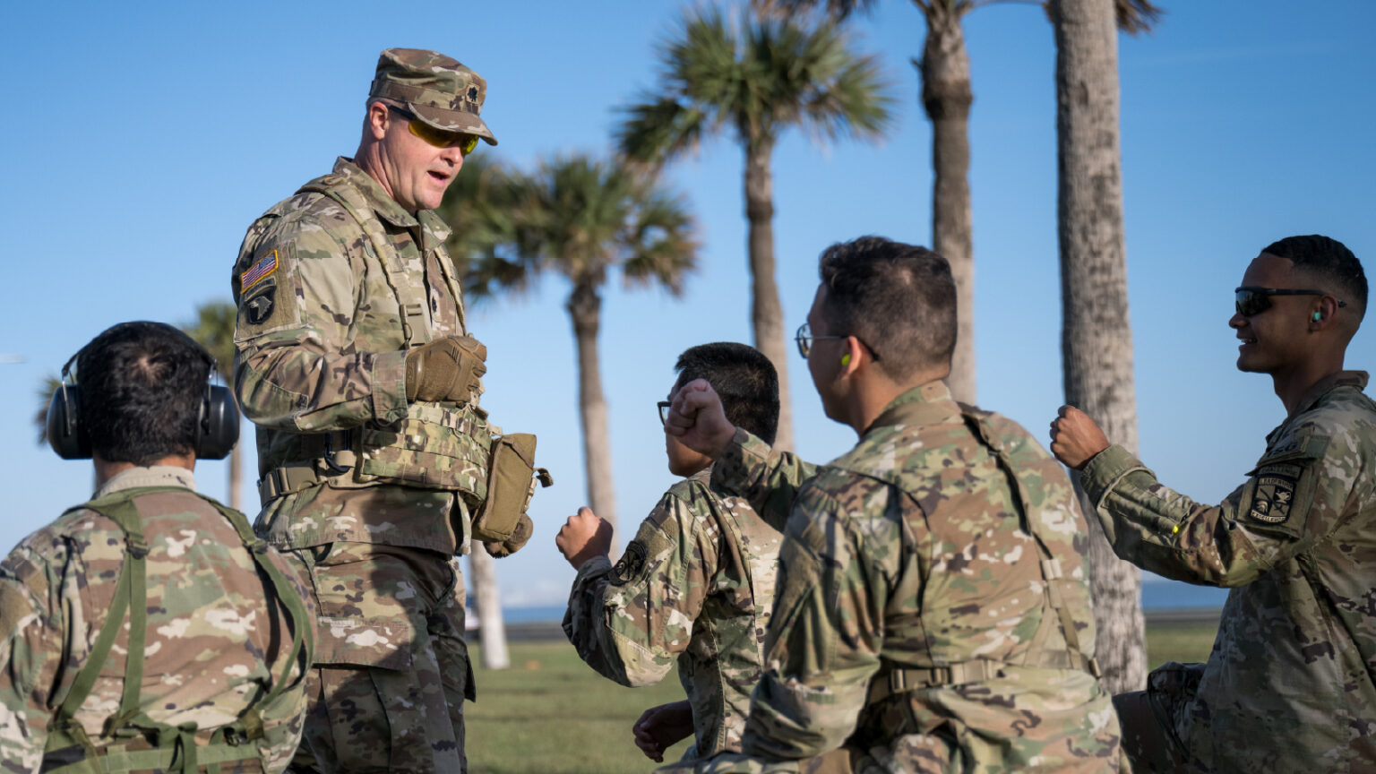 A photo of an officer speaking to soldiers.