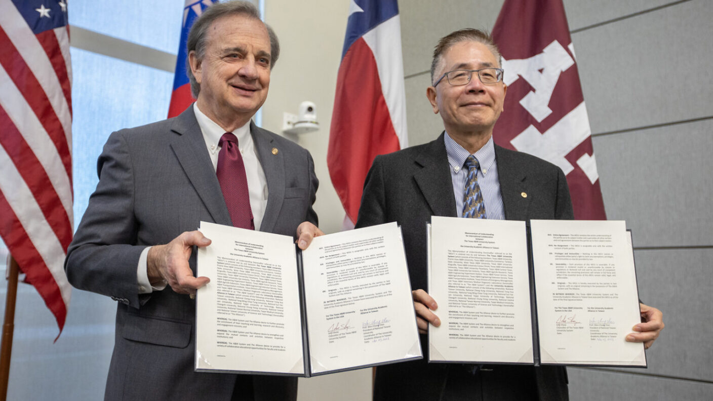 Picture of 2 leaders from a&m and taiwan respectively showing an agreement signed