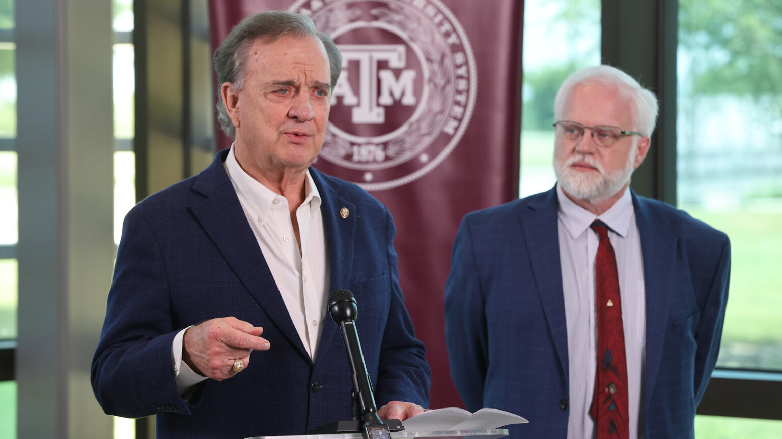 John Sharp speaking at a podium