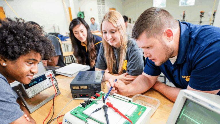 A group of East Texas A&M students huddled around a machine.
