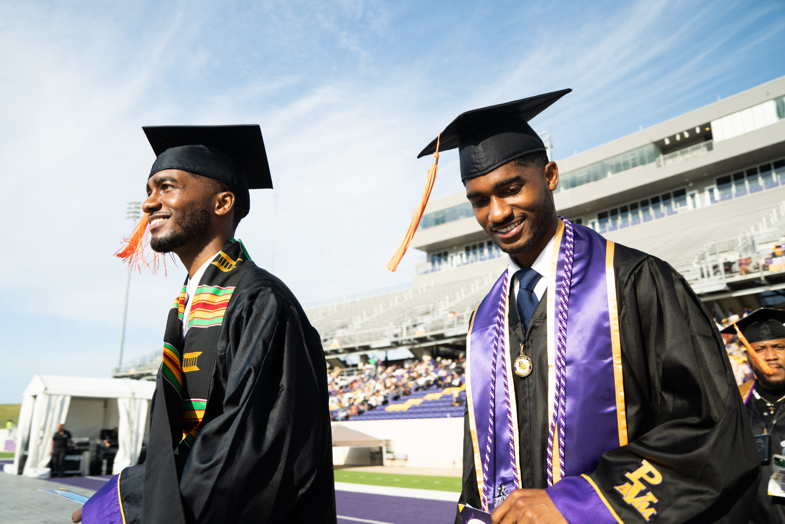 Two students in graduation regalia